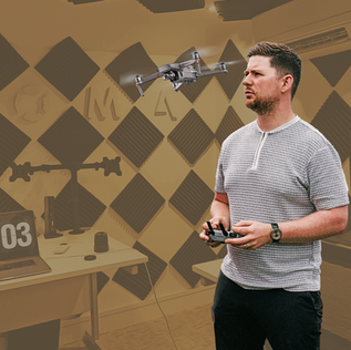 Richie Naylor, Content Director at ZOMA, operating a drone in a creative studio with acoustic panels, showcasing content creation technology and workspace setup.