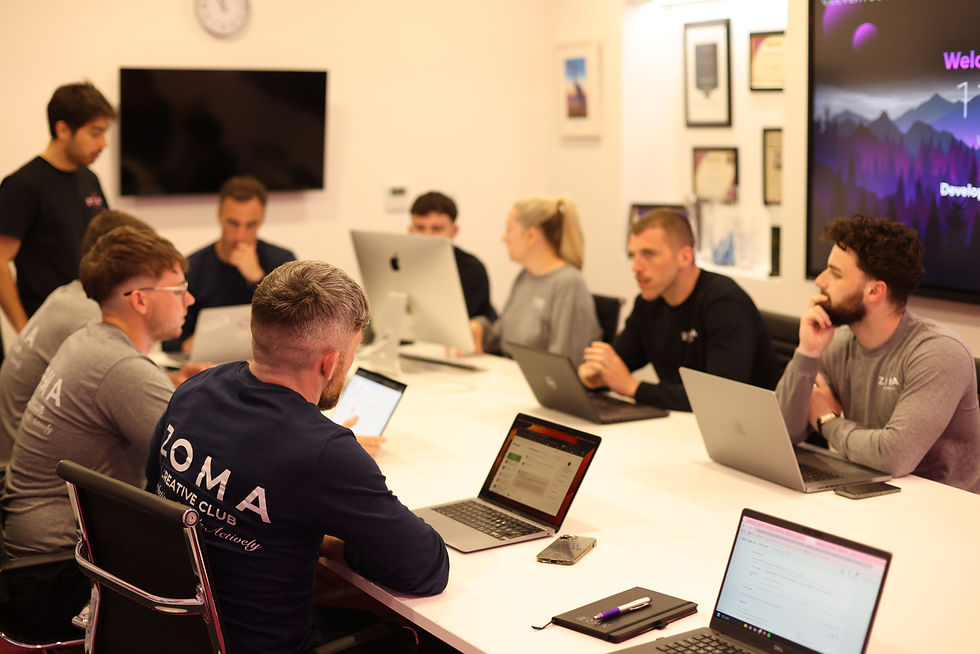 High angle view of a team discussing metrics on a digital tablet